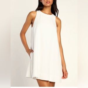 Lulu white linen dress. A line with side pockets and two button closure